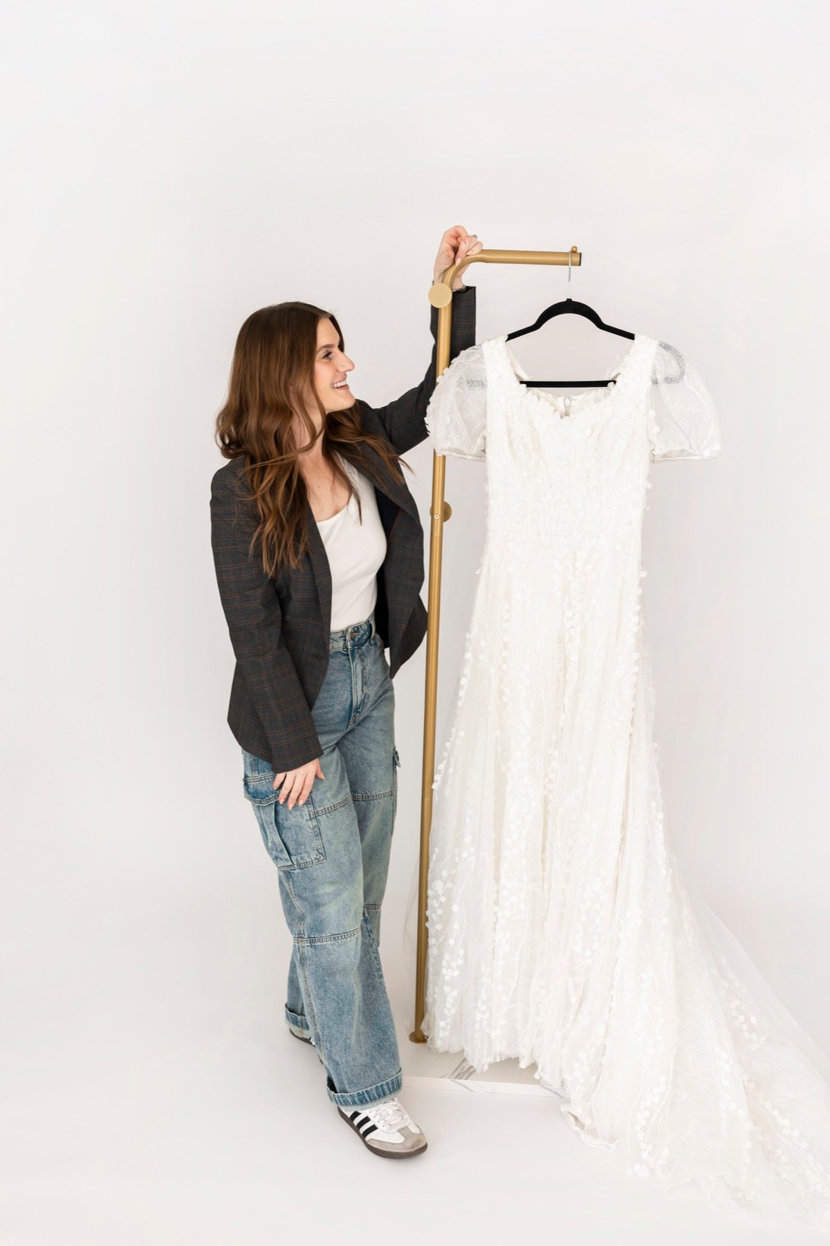 A Laurels & Lace stylist presenting a modest wedding gown
